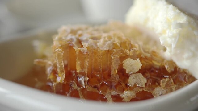 Honey and cream served in a small white dish in a cafe
