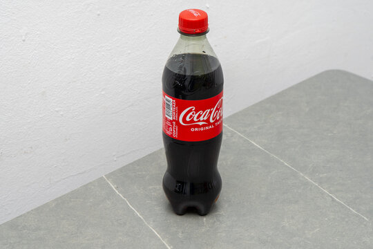 Coca-Cola pet bottle original taste 500ml. Red classic packaging. Gray background. Ukraine, Kyiv - April 21, 2025.