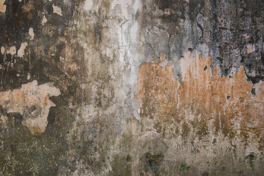 Old plaster wall in Vietnam with faded gray and brown marks, captured close-up for rustic texture, architecture, and abstract background concepts.