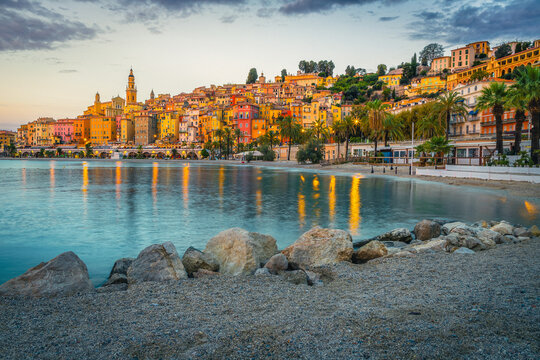Colorful mediterranean seaside buildings and gravelly beach in Menton, France