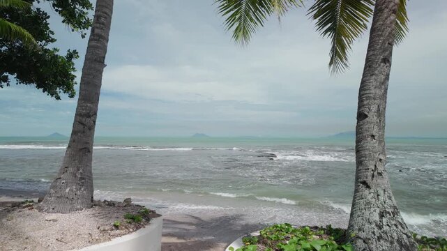 Cinematic View of Tropical Beach with Palm Trees and Distant Island in Anyer