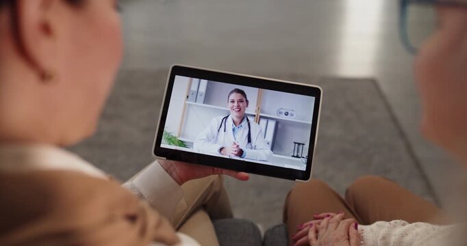 Senior woman on tablet telemedicine video call. At home she consults a doctor online, receiving advice via a secure virtual consultation. Concept shows reliable remote healthcare access.
