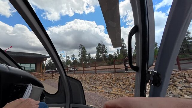 First person view of a tourist getting on a helicopter, fastening the seatbelt, and preparing for takeoff on a scenic flight over the grand canyon national park in arizona