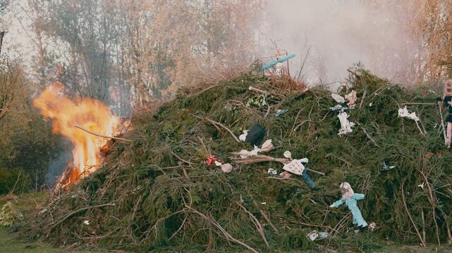 Ignition of large bonfire with flames rising during spring festival near Liberec Czech Republic Europe