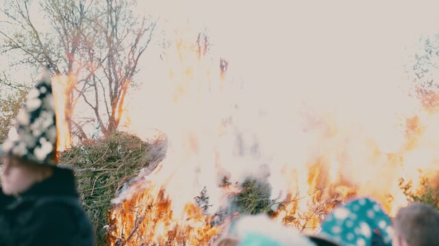 Ignition of large bonfire with flames rising during spring festival near Liberec Czech Republic Europe