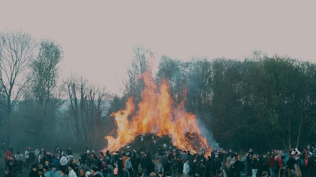 Man standing with burning bonfire in background during spring festival near Liberec Czech Republic Europe