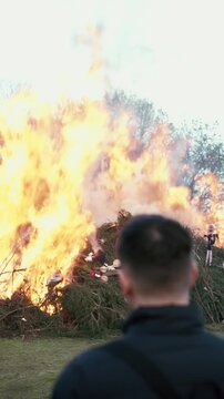 Man standing with burning bonfire in background during spring festival near Liberec Czech Republic Europe