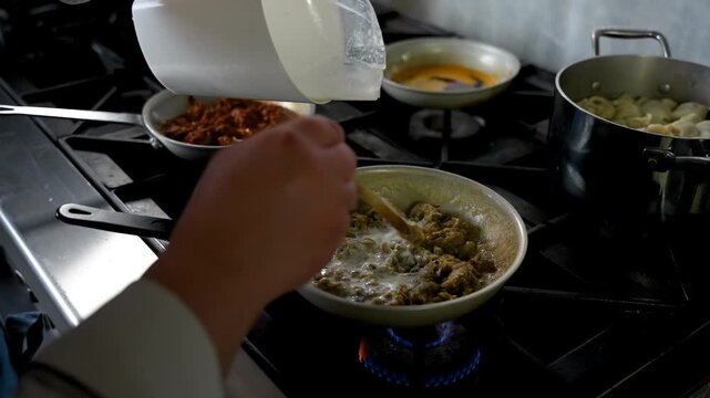 Chef Preparing Traditional Turkish H&uuml;nkar Beğendi With Roasted Eggplant and Milk