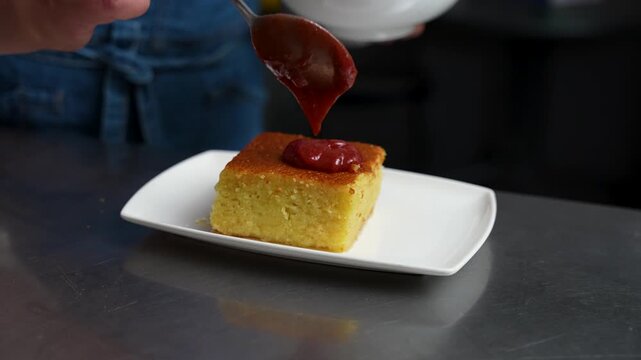 Plum Sauce Being Spread on Traditional Turkish Revani Dessert