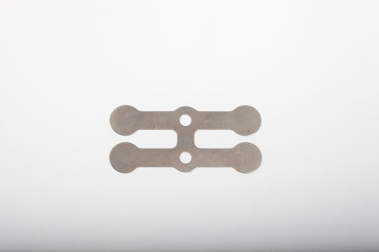 Metal valve reed for air compressor valve plate isolated on white background.
Studio shot of a stainless steel valve reed (valve plate strip/gasket) used in air compressor reed valve ass