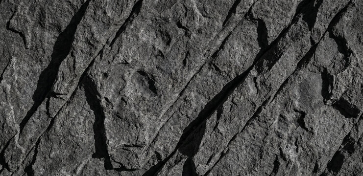 Close up of rough rock texture with deep diagonal fissures
