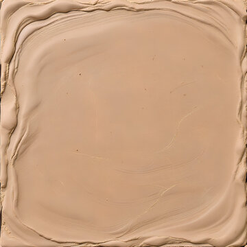 A close-up view of a light beige, creamy substance with textured edges and subtle swirls in the center, resembling a cosmetic foundation or paint.