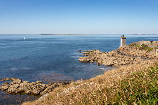 Panoramic view of fort, lighthouse and World War II blockhaus at Pointe de Kermorvan Le Conquet Finistere Brittany France with distant Beniguet and Molene islands under clear summer sky