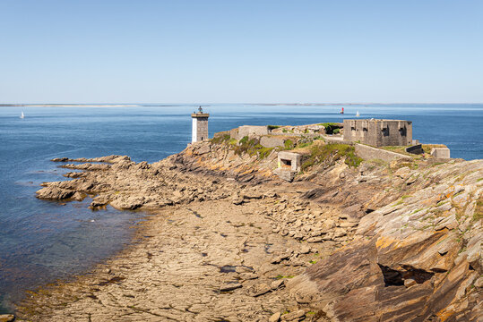 Panoramic view of fort, lighthouse and World War II blockhaus at Pointe de Kermorvan Le Conquet Finistere Brittany France with distant Beniguet and Molene islands under clear summer sky