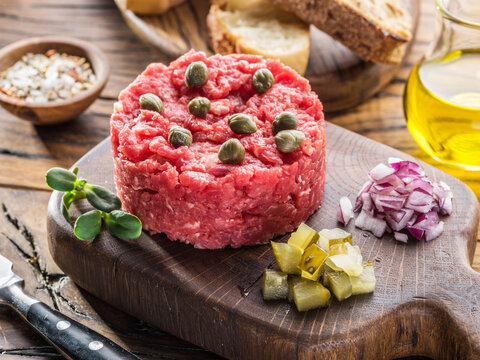 Steak tartare served with capers, pickled cucumbers and chopped onion.