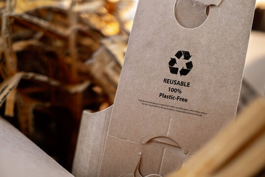 Close-up of recyclable cardboard packaging with reuse symbol, plastic-free concept. Sustainable materials and eco-friendly branding for environmental awareness.