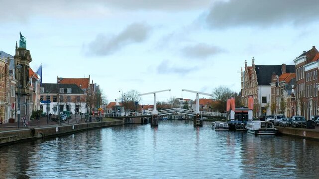 Haarlem, Netherlands. View of the city center in Haarlem, Netherlands during a cloudy winter day. River with people and car traffic