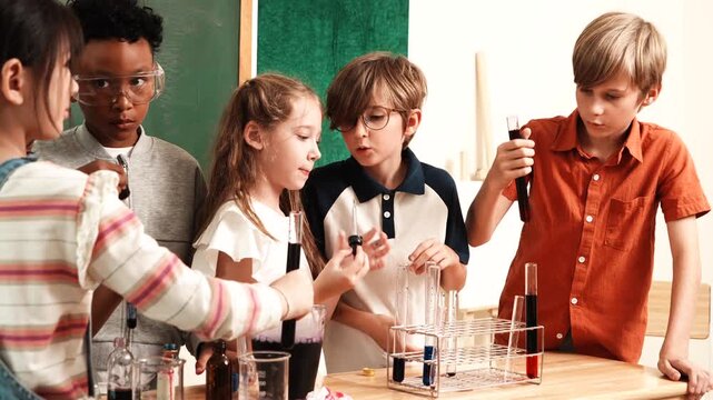 A group of boys and girls, of multinational nationality, friends stand in front of their classmates learning science, mixing chemicals, holding test tubes, having fun with experiments in their classro