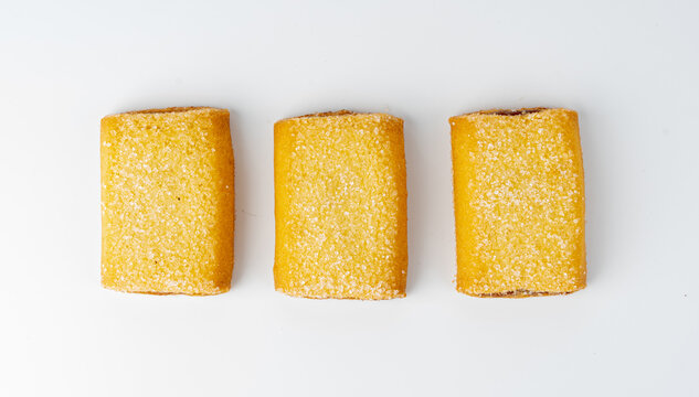 Fig roll bar, square sugar cookies with fruit filling isolated. Taiwanese pineapple cake, brown rectangular strudel biscuits, sweet apple roll pastry on white background