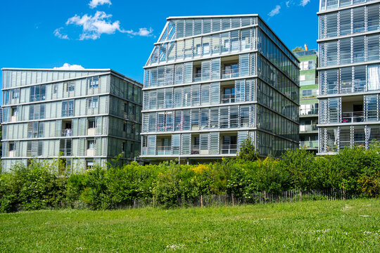 Glass, greenery and facade rhythm define architecture at La Confluence in Lyon, France, around an urban building exterior with clear daylight use