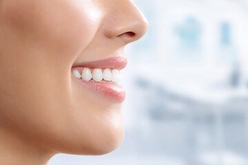 Obraz premium Close up of a beautiful woman's perfect white smile and teeth in a dental clinic background.