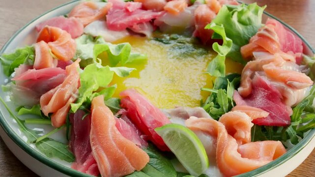 A close-up shot of delicious fresh seafood carpaccio with tuna, salmon, and white fish.