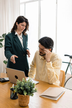 Boss reprimanding employee during a stressful office argument