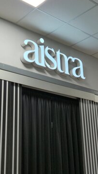Vilnius Lithuania 02.04.2026 Aistra intimate boutique entrance with illuminated logo black curtains and striped monochrome interior design inside modern shopping mall