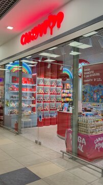 Vilnius Lithuania 02.04.2026 Candypop candy store interior in shopping mall with colorful sweets display shelves neon lights and modern confectionery retail design concept