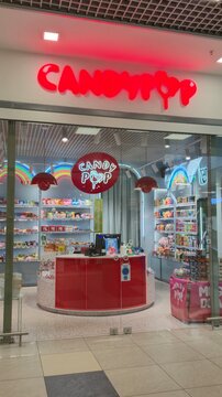 Vilnius Lithuania 02.04.2026 Candypop candy store entrance in shopping mall with colorful sweets shelves neon rainbow lights and modern confectionery retail interior design