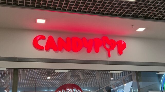 Vilnius Lithuania 02.04.2026 Candypop candy store sign in shopping mall with glowing red logo modern retail branding and confectionery shop interior background