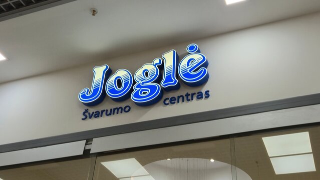 Vilnius Lithuania 02.04.2026 Jogle cleaning center illuminated sign in shopping mall with modern branding laundry service logo and commercial retail interior concept