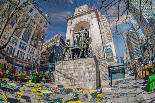 NEW YORK, USA - MARCH 7, 2020: Herald Square at intersection on 6th Avenue with Broadway and W 34th St. The James Gordon Bennett Monument with three statues and a bell, carved by A. J. P. Carles.