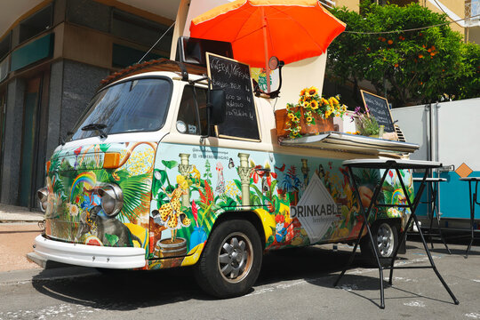 DIANO MARINA, ITALY - MAY 9, 2026: Vintage Volkswagen van converted into mobile bar called Drinkable at Aromatica festival. Colorful artistic wrap and floral decorations attract visitors during annual