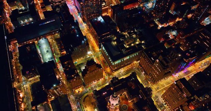 Fantastically illuminated cityscape with lively traffic on roads. Beautiful scenery of Philadelphia, Pennsylvania, USA at night from drone.