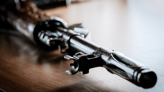 Rusty rifle lies on dark wooden surface