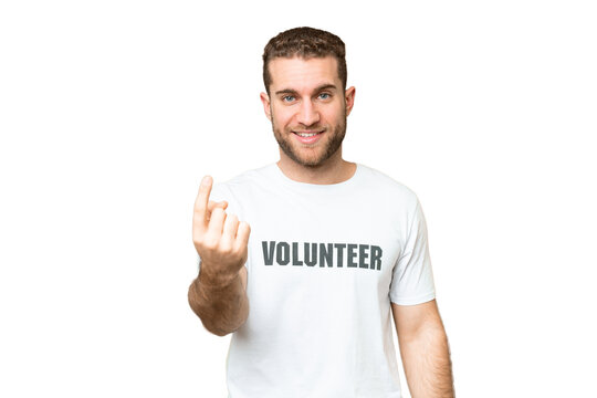 Young volunteer man over isolated chroma key background doing coming gesture