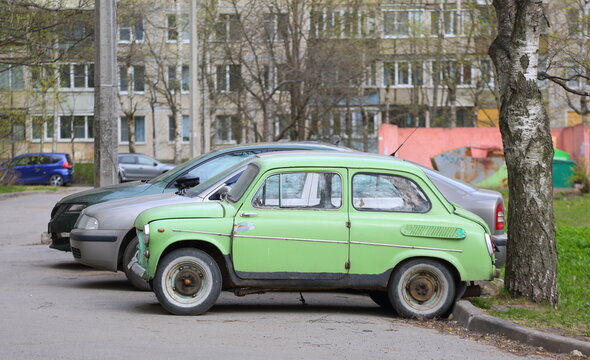An old Soviet light green car is parked in the courtyard, Iskrovsky Prospekt, Saint Petersburg, Russia, April 22, 2026