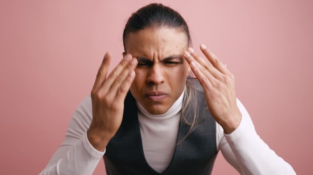 Confused and angry man with long hair going through a range of emotions, from frustration and stress to happiness and confidence