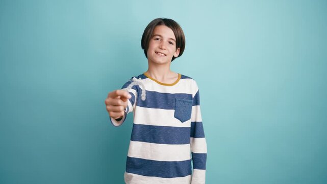 Happy teenage boy holding a transparent orthodontic retainer. Modern invisible braces for dental correction and a beautiful smile concept