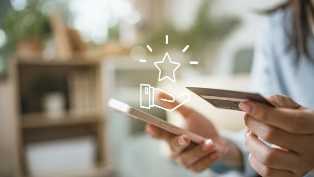 Customer using smartphone and card with reward icon, representing redeem points, loyalty rewards, cashback offers, digital vouchers and mobile payment benefits.