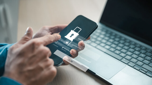 User logging into secure mobile account with password screen beside laptop, representing MFA, two factor authentication, identity verification and cybersecurity protection for digital access.
