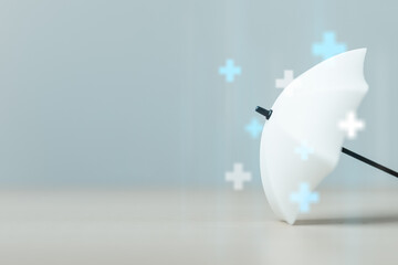 White umbrella symbolizes health insurance protection, medical coverage and financial security for healthcare expenses. Ideal for wellness plans, hospital care, policy benefits. © Garun Studios