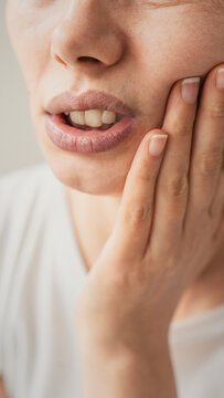 Young woman suffering from toothache