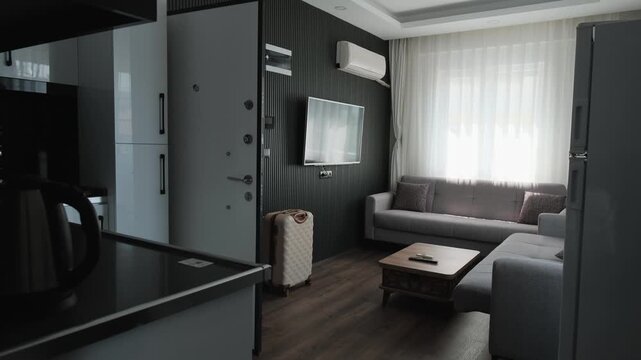 Traveler checking out from furnished apartment with luggage, leaving temporary accommodation after short stay, travel lifestyle and digital nomad departure concept