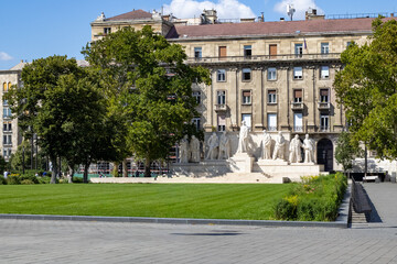 Fototapeta premium Monument made of white stone against the background of a house