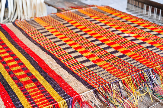 colorful handwoven textile on traditional loom close up