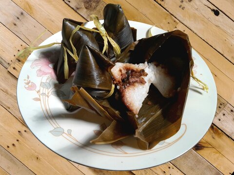 Bacang, or bak chang, is a dish typically made from rice filled with seasoned minced meat and wrapped in bamboo leaves.