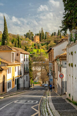 Fototapeta premium Granada, Spain. Historical streets of Spanish Granada. The Alhambra Palace complex. Beautiful Spanish city. Travel, Tourism 