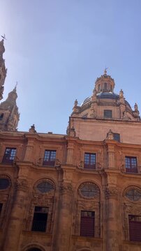 Salamanca University with its historic facade and ornate Plateresque architecture under a bright sky in Salamanca, Spain
